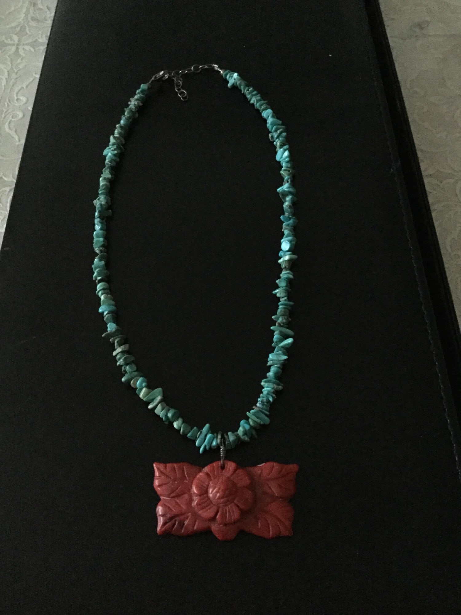 Turquoise and Coral Necklace: Title: Turquoise and Coral Necklace Description: A great summer necklace with turquoise stones and coral pendant with sterling silver clasp. Condition: Used Delivery option: Collection &