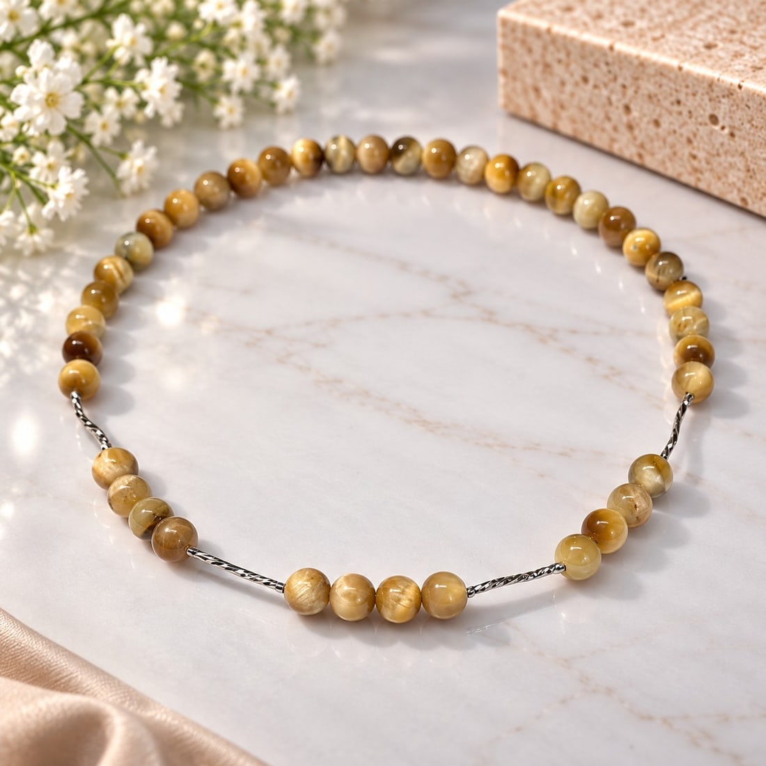 Golden Brown Beaded Necklace with Silver Tone Accents: Title: Golden Brown Beaded Necklace with Silver Tone Accents Description: Elegant beaded necklace featuring polished round beads in warm golden, honey and brown tones. The design is accented with