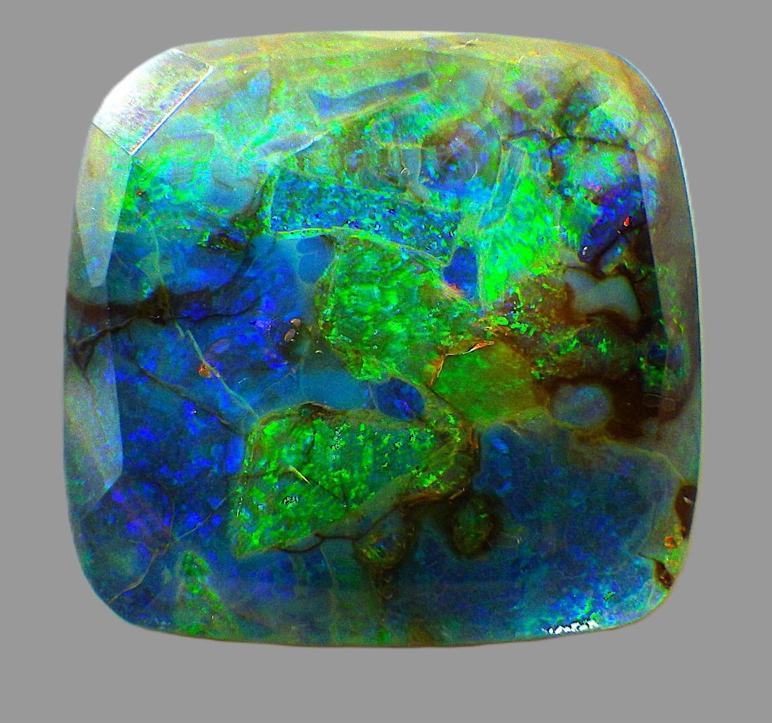 Triplet Monarch Opal 23 Carats: Title: Triplet Monarch Opal 23 Carats Description: A mesmerising triplet Monarch Opal in the form of a rectangular multi-faceted gemstone. Hues mainly blue & green. Dimensions: 20.0 x