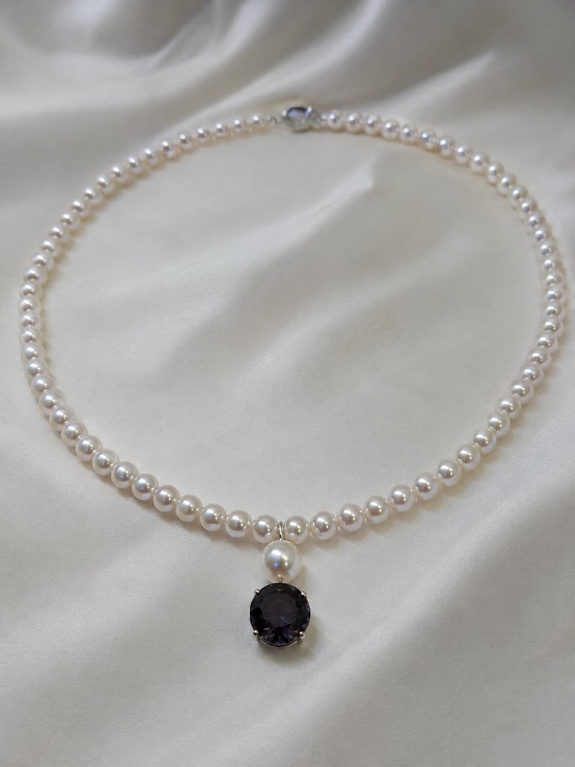 Pearl Necklace with 10mm Alexandrite & 925 Sterling Silver Clasp: Title: Pearl Necklace with 10mm Alexandrite & 925 Sterling Silver Clasp Description: Elegant pearl necklace featuring a striking 10mm faceted alexandrite centre stone. Finished with a 925 sterl