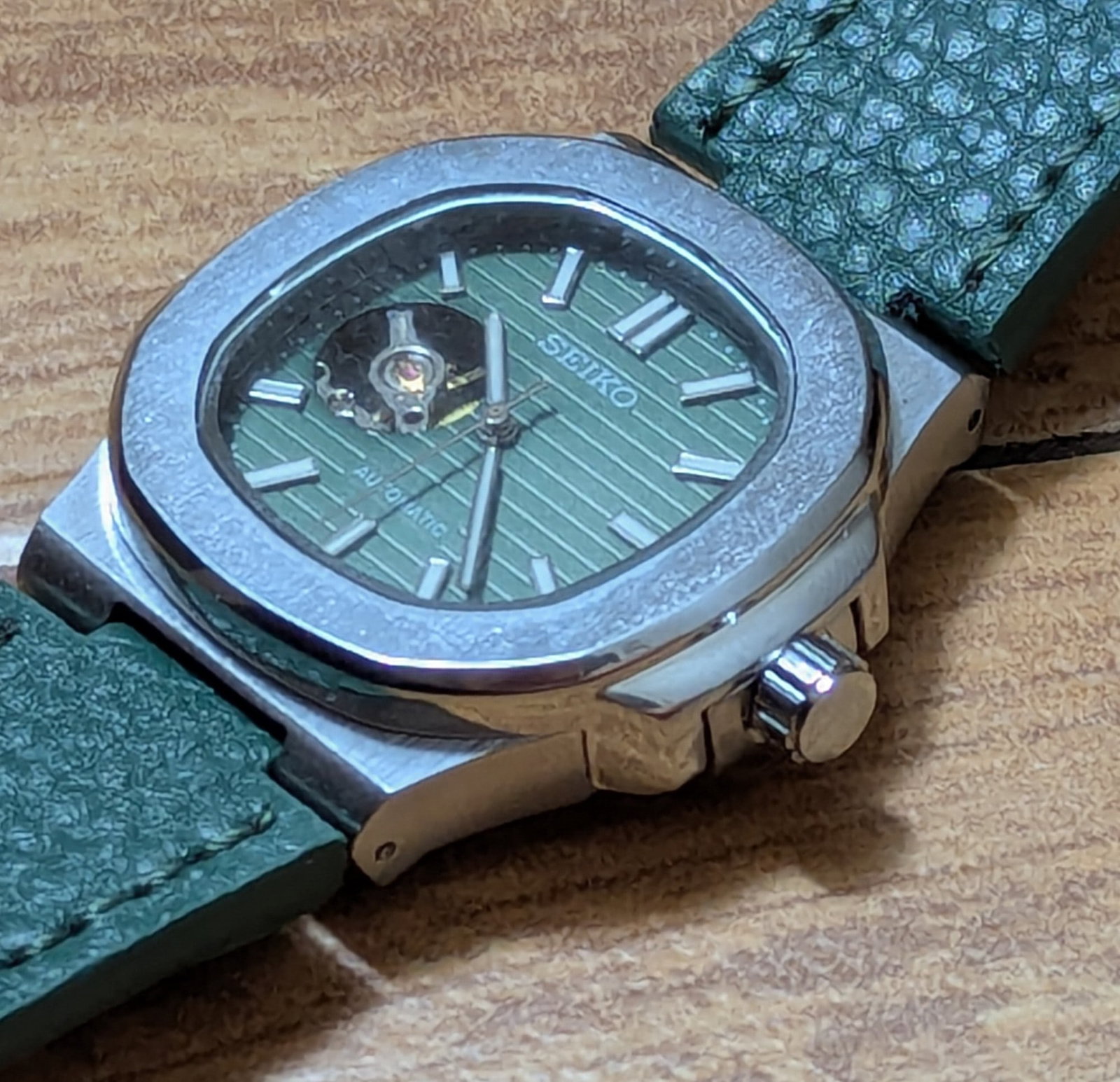 Seiko Automatic Open Heart — Green Dial Sports-Luxury Watch: Title: Seiko Automatic Open Heart — Green Dial Sports-Luxury Watch Description: This Seiko automatic pairs a deep green, horizontally textured dial with a skeletonized aperture that reveals t