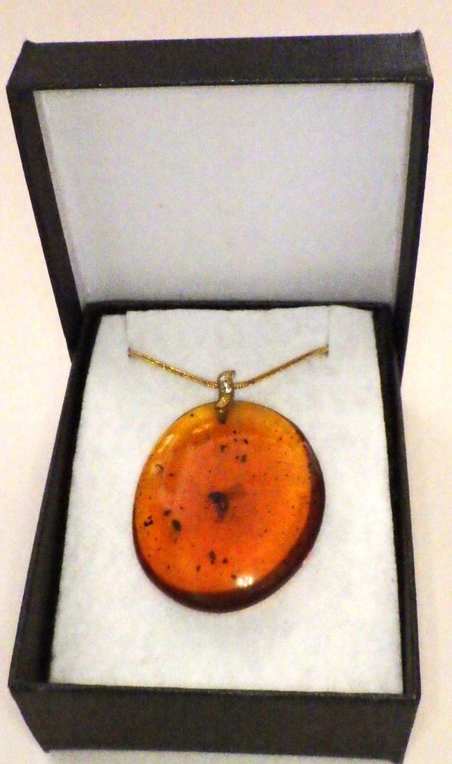 Amber Resin Pendant With Mosquito Inclusion: Title: Amber Resin Pendant With Mosquito Inclusion Description: A very attractive amber resin pendant with an insect inclusion. Dimensions: 41 x 35 x 11 mm. With a gold plated bail adored