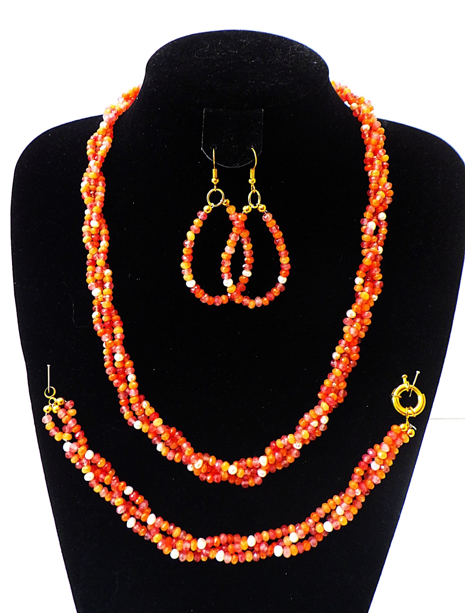 A Jewellery Set With Faceted Carnelian & White Cultured Pearls: Title: A Jewellery Set With Faceted Carnelian & White Cultured Pearls Description: An amazing necklace, bracelet and earrings set consisting of three braided strings with round faceted natural