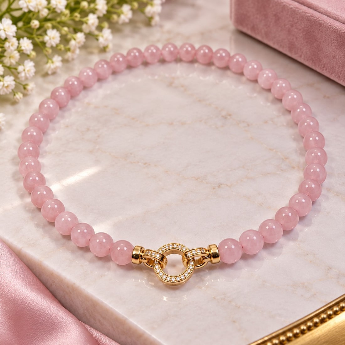 Pink Beaded Necklace with Gold Tone Crystal Clasp: Title: Pink Beaded Necklace with Gold Tone Crystal Clasp Description: Elegant necklace featuring polished soft pink round beads with a decorative gold tone circular clasp set with sparkling clear
