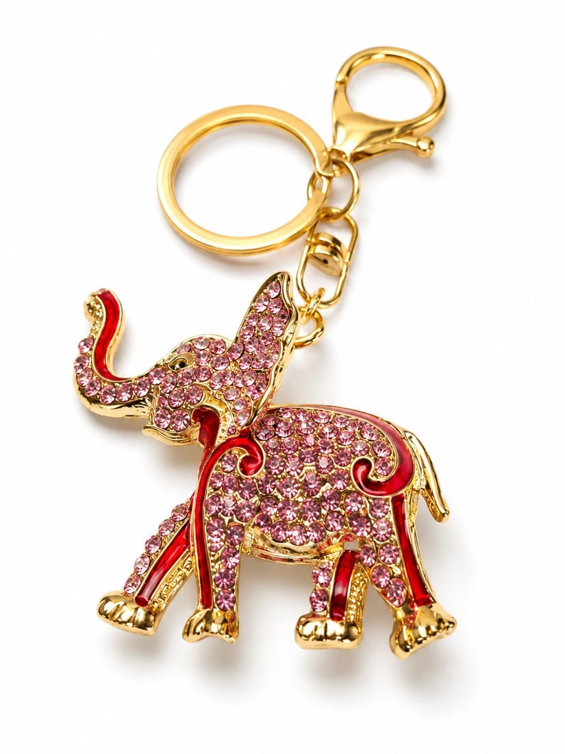 Pink Crystal Elephant Keyring - Gold Tone: Title: Pink Crystal Elephant Keyring - Gold Tone Description: Decorative elephant-shaped keyring in gold-tone metal, embellished with sparkling pink crystals and red enamel-style detailing. Complete