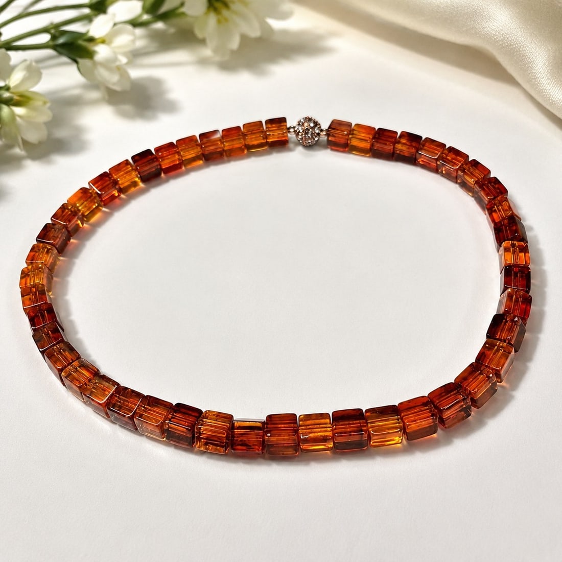 Amber-Coloured Translucent Cube Bead Necklace: Title: Amber-Coloured Translucent Cube Bead Necklace Description: Attractive necklace composed of translucent amber-coloured cube beads in warm orange and reddish-brown tones, finished with a
