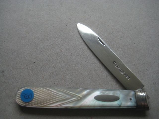 Victorian Mother of Pearl Hafted Silver Bladed Folding Fruit Knife: Title: Victorian Mother of Pearl Hafted Silver Bladed Folding Fruit Knife Description: Victorian Mother of Pearl Hafted Silver Bladed Folding Fruit Knife. The handle is carved into a