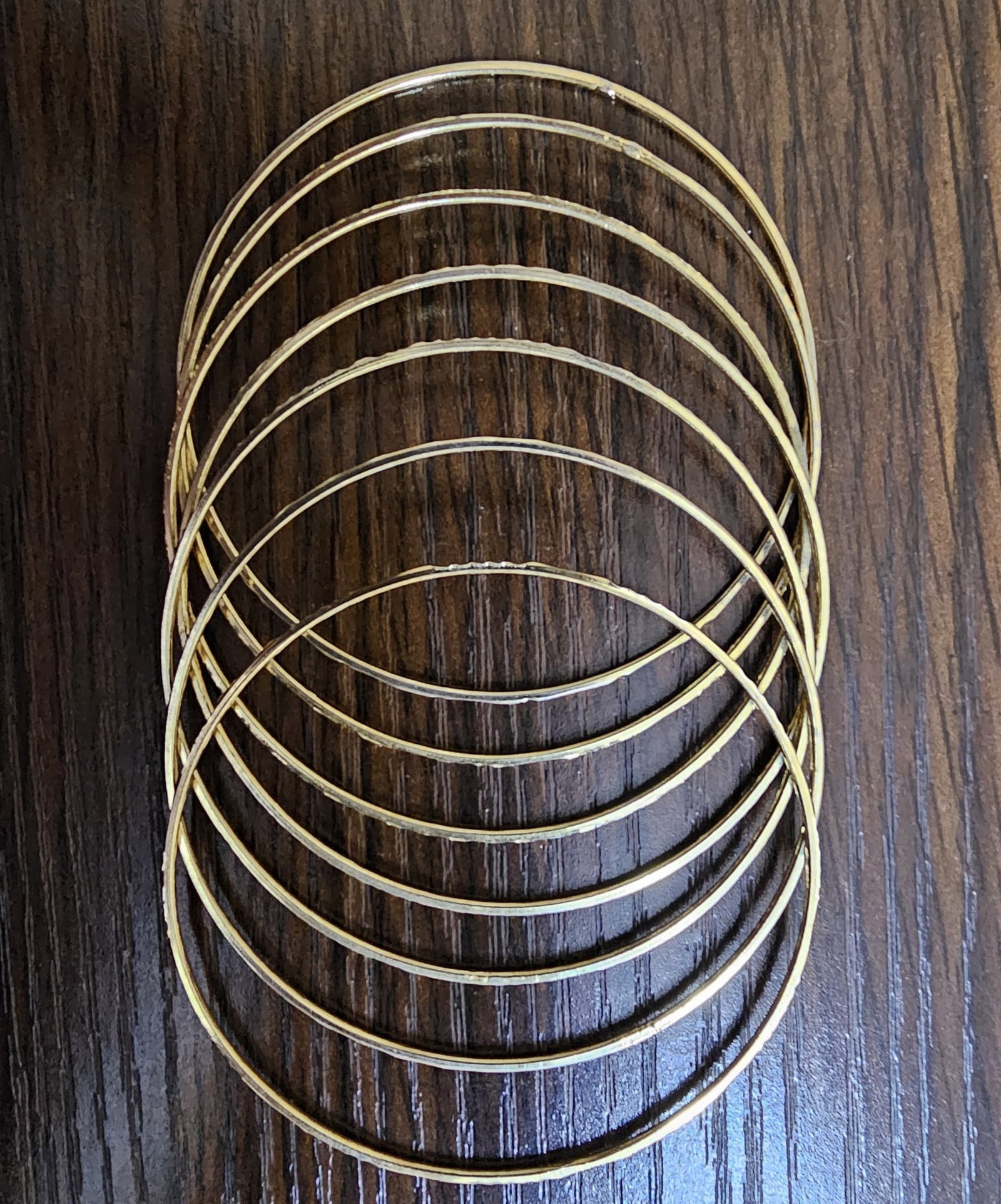 Set of 7 Yellow Metal Bangles – Stylish Everyday Wear: Title: Set of 7 Yellow Metal Bangles – Stylish Everyday Wear Description: Lovely set of seven yellow metal bangles being offered from my personal jewellery collection. These have a