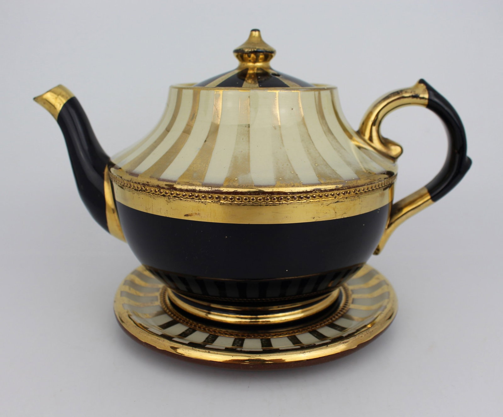 Decorative Lustre Terractotta Tea Pot on Stand: Title: Decorative Lustre Terractotta Tea Pot on Stand Description: Decorative Lustre Terractotta Tea Pot on Stand. Measures 23 x 15 x 16 (height) cm. Good condition; no cracks or repairs, light