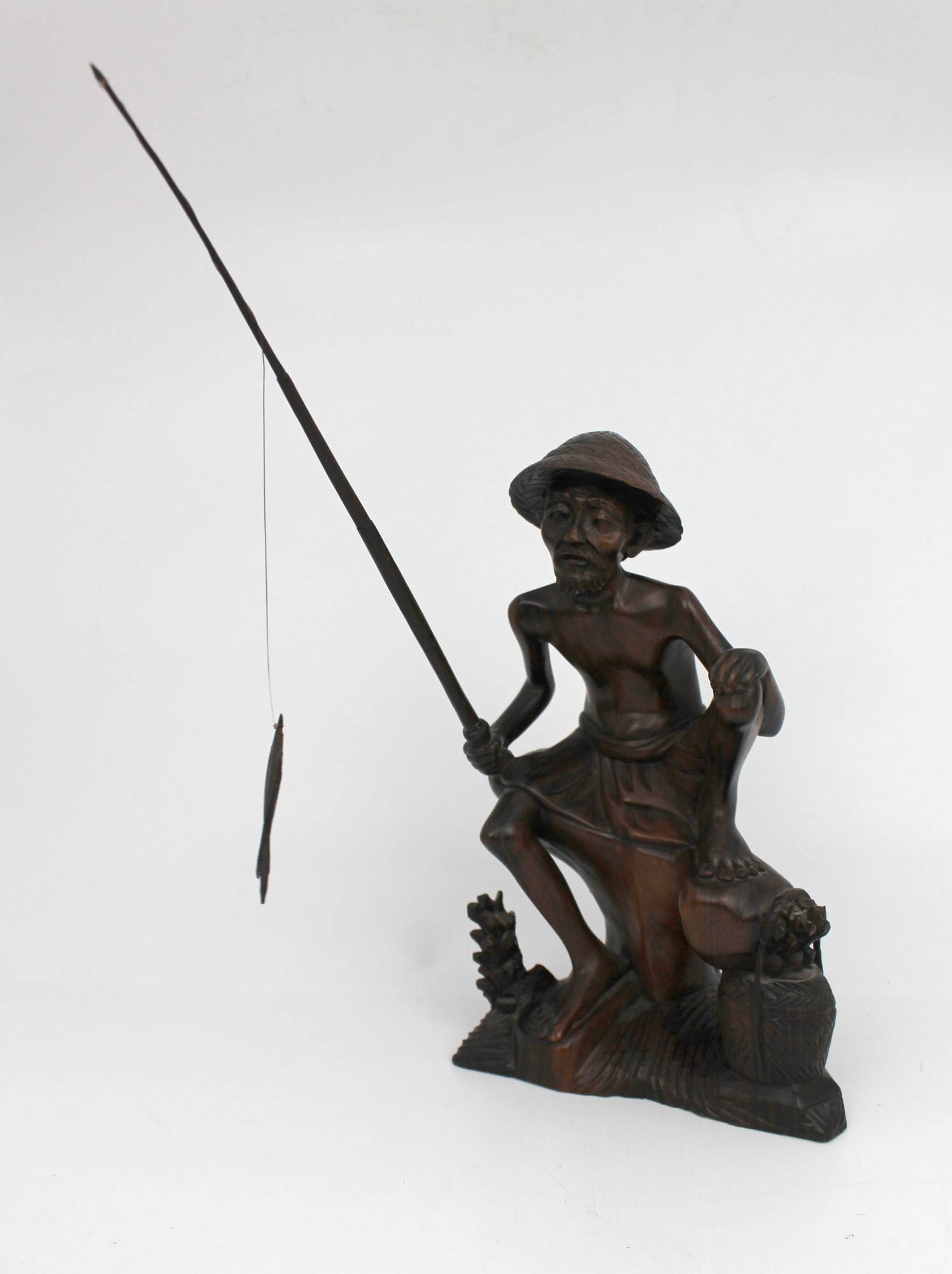 Mid-20th Century Balinese Hand-Carved Hardwood Fisherman Figure: Title: Mid-20th Century Balinese Hand-Carved Hardwood Fisherman Figure Description: Mid-20th Century Carved Wooden Figure of a Fisherman Carved wooden figure of a seated fisherman, likely made in