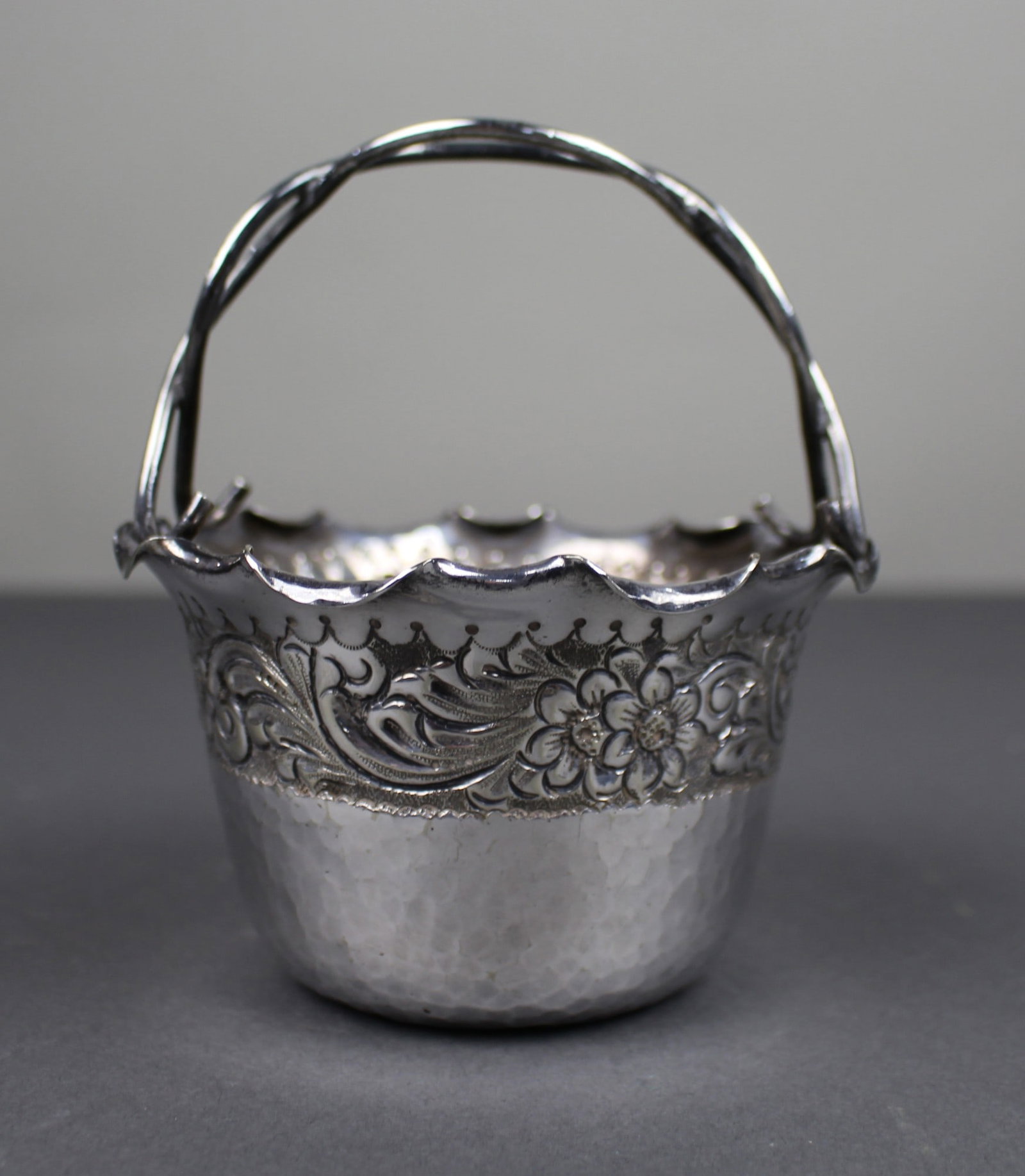 Antique Silver Plated Handled Basket: Title: Antique Silver Plated Handled Basket Description: Antique Silver Plated Handled Basket Decorative floral band with hammered lower section. Marked to the underside EPNS D S & G. Measures 12