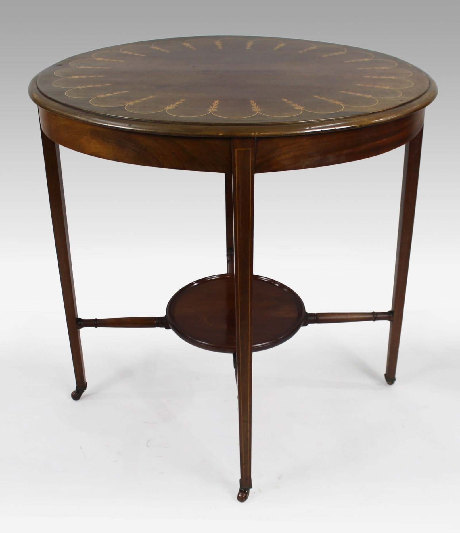 Edwardian Inlaid Oval Side Table: Title: Edwardian Inlaid Oval Side Table Description: Edwardian Inlaid Oval Side Table Oval form top with inlaid satinwood Neoclassical decoration. Moulded edge. Carried on four tap
