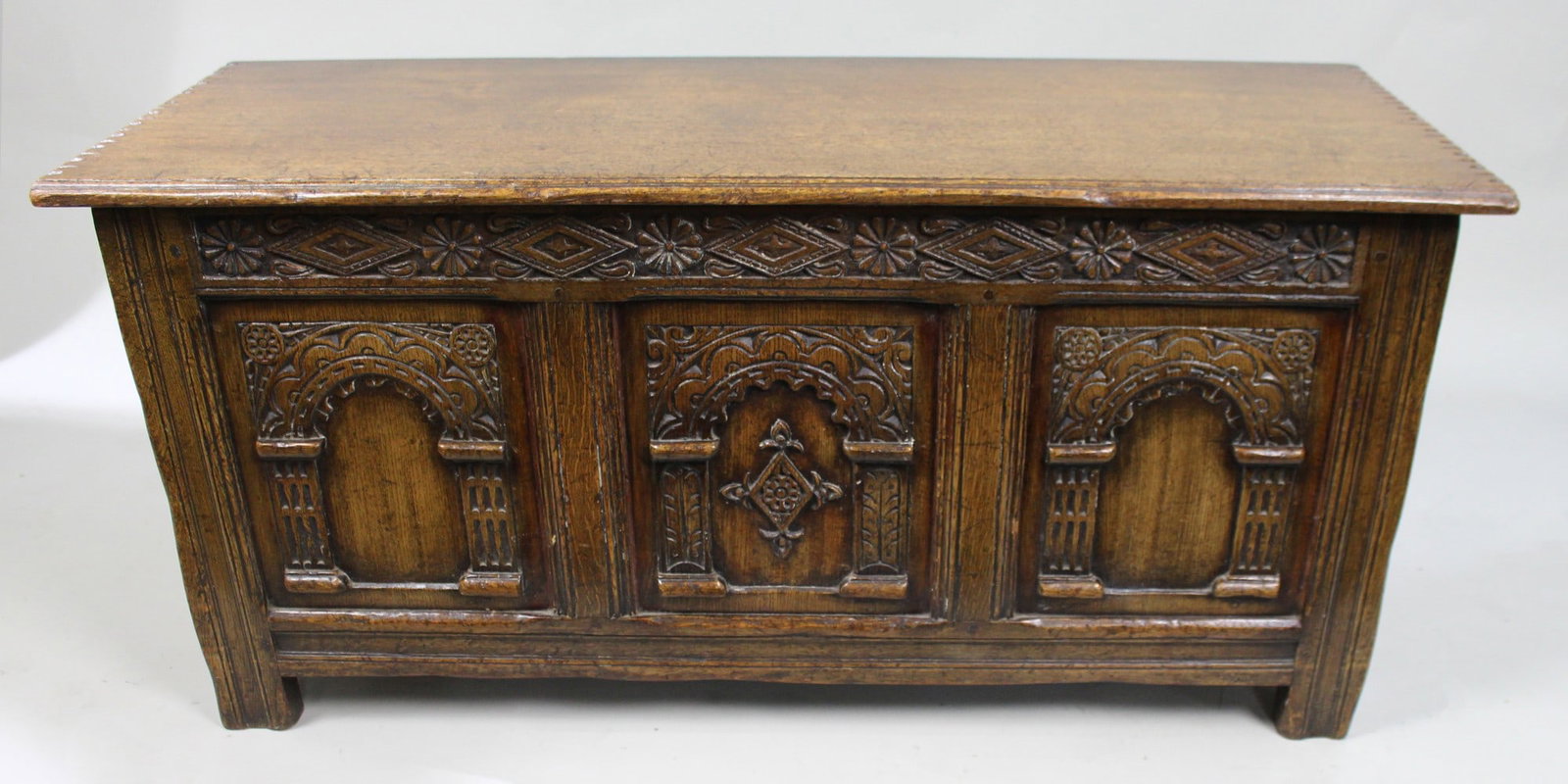Heavily Carved Oak Coffer in the Jacobean Taste: Title: Heavily Carved Oak Coffer in the Jacobean Taste Description: Mid-20th Century English Carved Oak Coffer in the Jacobean Taste A decorative carved oak coffer executed in the traditional