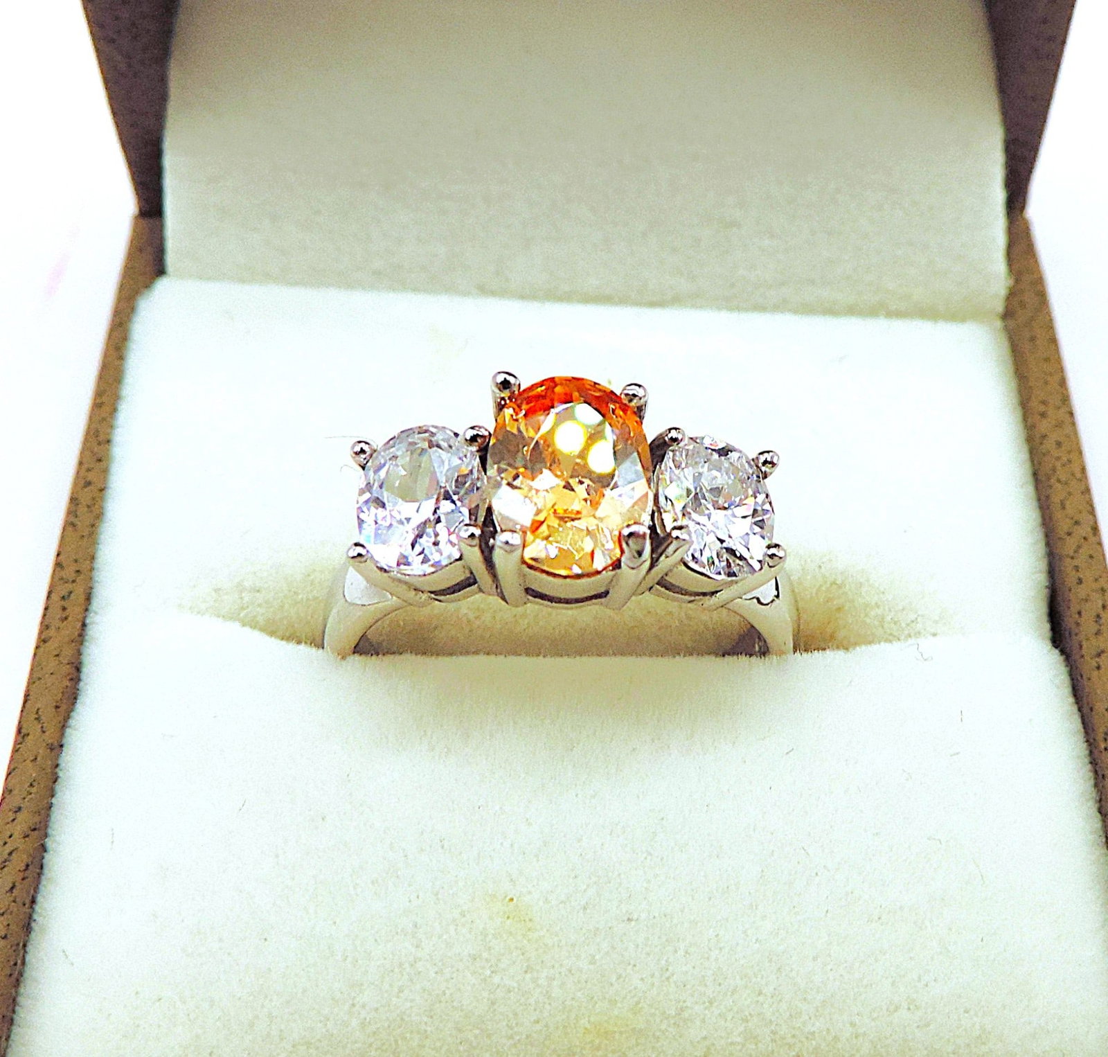 Sterling Silver Gemstone Ring New With Gift Pouch: Title: Sterling Silver Gemstone Ring New With Gift Pouch Description: A lovely ring in sterling silver set with 1 x 7 x 5mm orange gemstone and 2 x 5 x 4mm sparkling white gemstones. Ring size