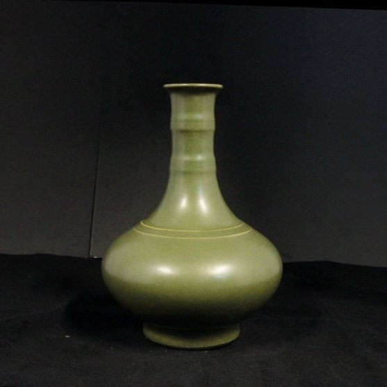 Qing Dynasty Tea Dust Glazed Pear-Shaped Vase: Measurement: Diameter of mouth 1.75 in., L 5.5 in., H 7.875 in. The compressed globular body rises to a cylindrical neck, and covered overall with a finely speckled glaze of olive-brown tone. Tea-dust