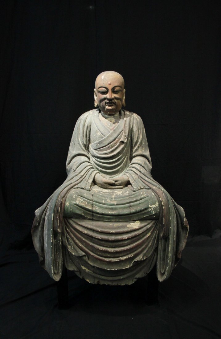 Important Northern Song Dynasty Wood Polychrome Luohan: L 31 in., W 21 in., H 42.25 in. This was a rare wooden Luohan of the Song Dynasty (960-1279). It was amazing that most of the coloring was still left intact after more than 1000 years. The facial expr