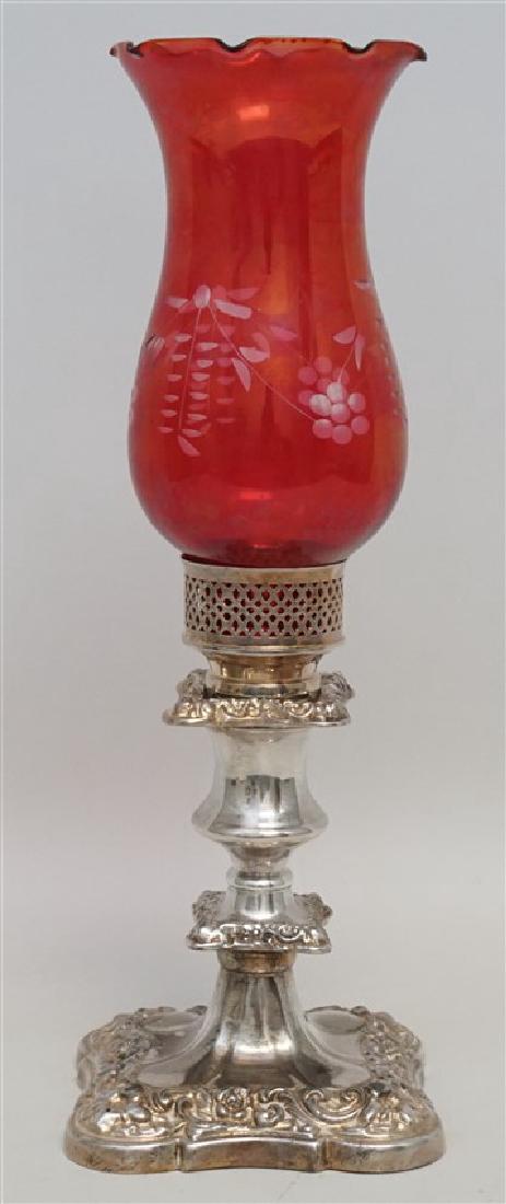 SILVER CANDLESTICK CRANBERRY SHADE: Ornate Silver Plate Candlestick with etched Cranberry Glass Hurricane Shade. The candlestick has a square base and is weighted, measures 4"x4"x6.75". The shade has a ruffled top with etched floral and