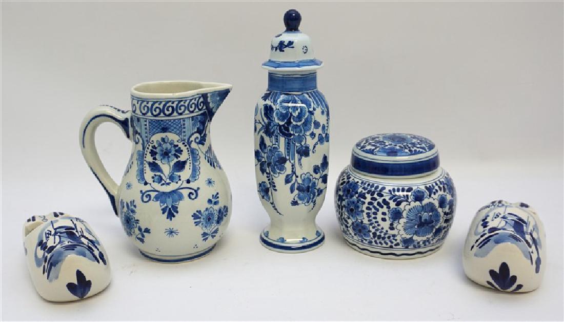4 PC DELFTS DE PORCELEYNE FLES: 1 - Small Jug 5.25" date mark 1948. 2- Lidded Jar 3.25" date mark 1958. 3- Tall lidded jar, nick to lid edge, date mark 1966. 4- A pair of Porcelain Dutch Shoes, simply marked Delft, each 4.50" long.