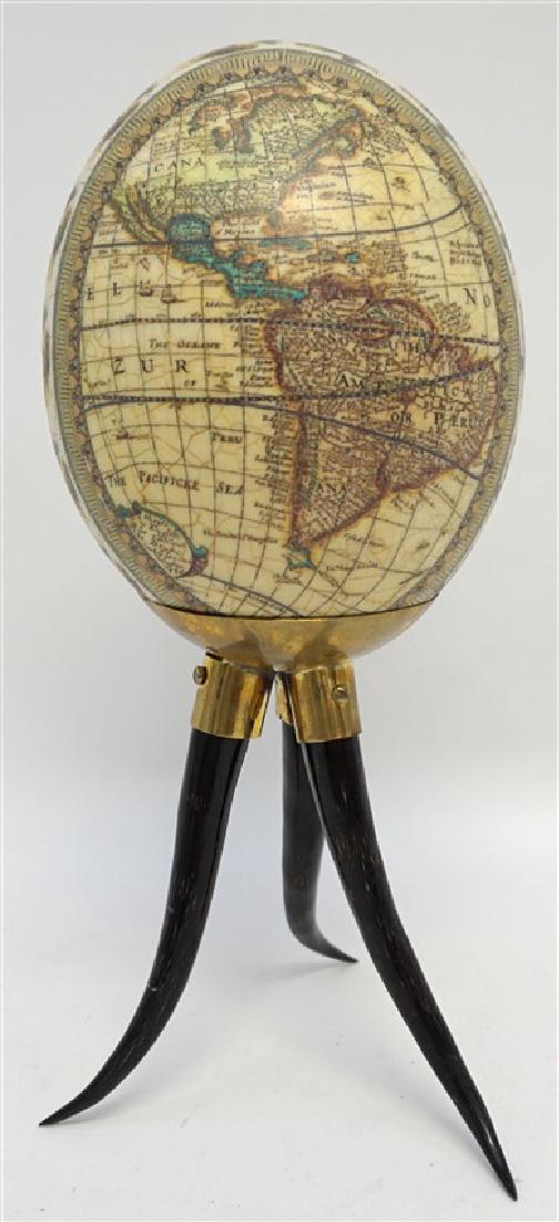DECOUPAGE WORLD MAP EGG ON HORN STAND: Decoupage World Map ostrich egg on Horn Stand. African Ostrich egg with detailed world map and a central band of African Animals on a three horn stand with brass. On stand measures 4.50"x4.50"x11.25".