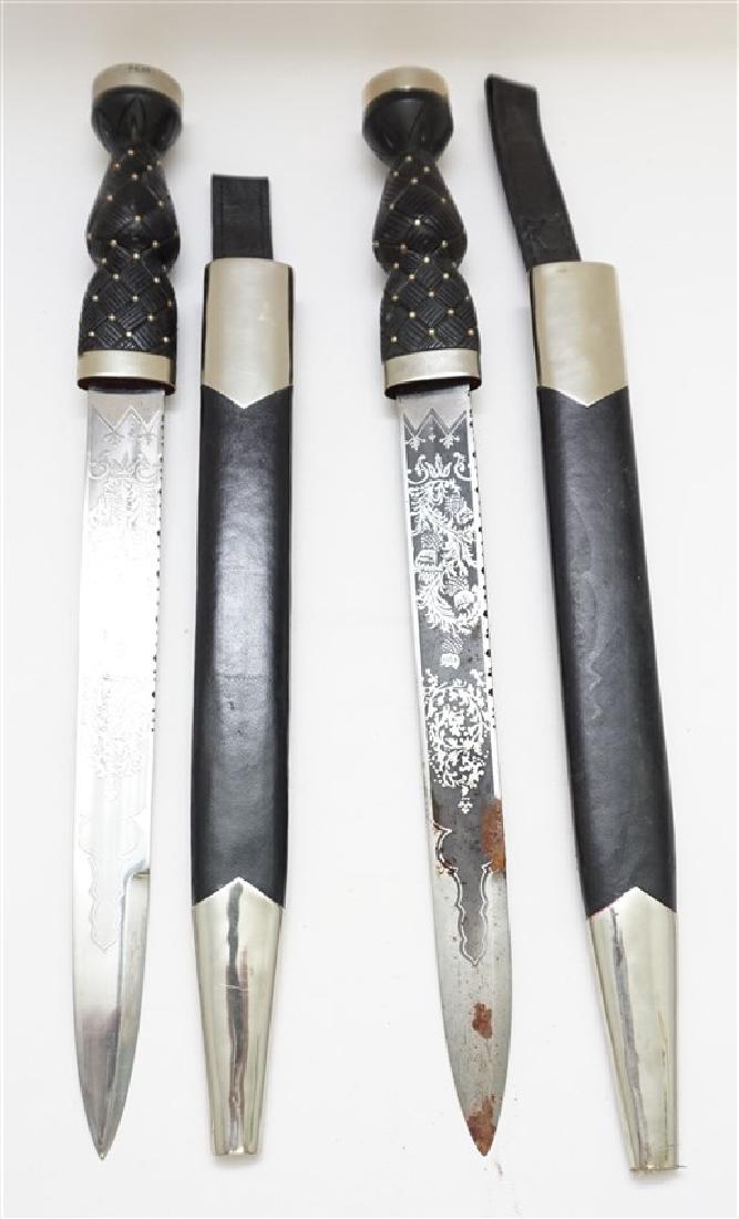 PAIR SCOTTISH DIRKS W THISTLE ENGRAVING: New old Stock. A matched pair of Scottish Dirks with thistle engraved blades and with cross-hatched studded handles in the shape of a thistle. With sheaths. Perfect for the Scottish Games or Festivals