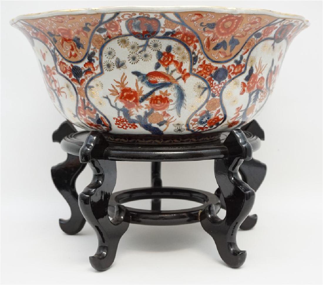 LARGE CASTILIAN PORCELAIN BOWL ON STAND: Large Castilian Porcelain Imari Bowl on Ebony Wood Stand. Bowl measures 17"x17"x7" and 13.5" tall on the stand. Weight is 19 pds. Castilian imports is well known for its highly detailed porcelain and