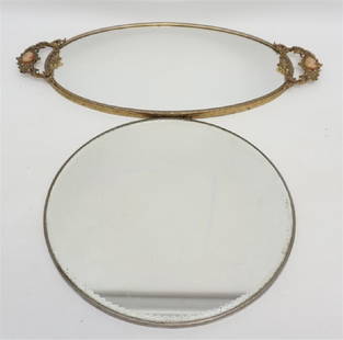 2 VINTAGE MIRRORED VANITY TRAYS: 1- Round Fancy Beveled Glass Edge Vanity Mirror in plain silverplate frame 12"x12". 2- Vintage Ornate Cast Brass Vanity Mirror Tray with Cameo accented handles 19"x9". Weight on both combined 5 pds. G