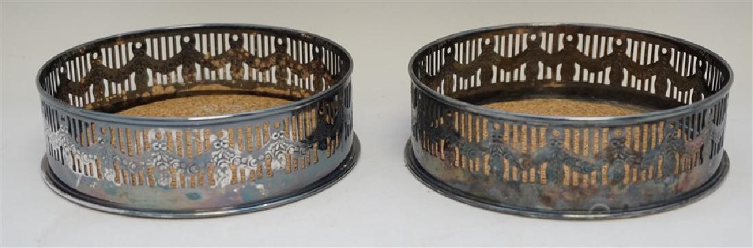 TWO WOLFF WINE COASTERS: A matched pair of Vintage Brazilian Soppil Wolff silver plate Wine Coasters. Both in good condition, needing a polish. Cork inserts. A elegant addition to any table where wine is being served. Each 4.