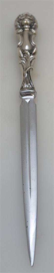 WALLACE STERLING LION LETTER OPENER: A sterling silver handle letter opener by Wallace Silversmiths in the Lion pattern by Frank Smith. This features a long stainless steel tapering blade with a sterling silver hollow handle in the form