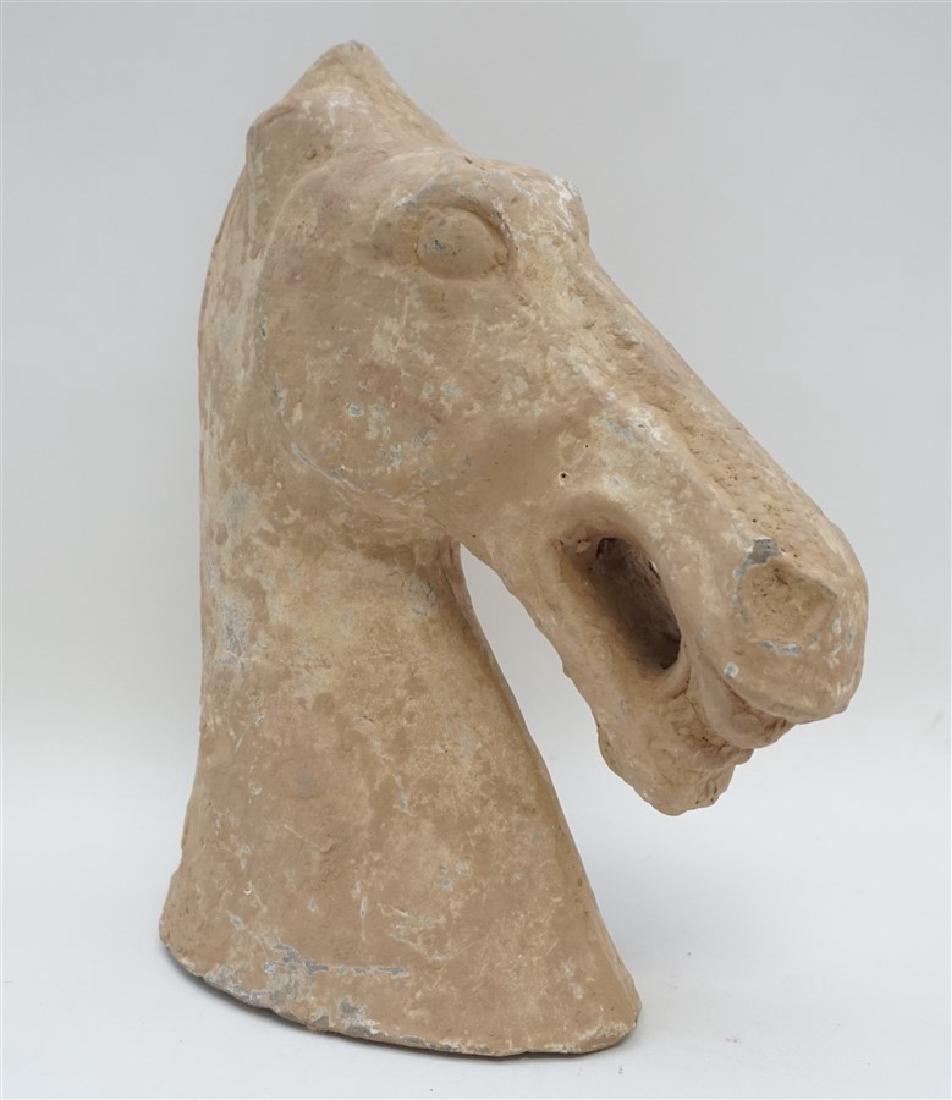 CHINESE TOMB POTTERY HORSE HEAD: Chinese Tomb Pottery Horse Head, probably Han Dynasty. Partial Tomb Figurine, Han Dynasty. Hole at the top where some type of ornamentation or horse hair once was. Measures 9"x3.40"x12" tall. Weight 5