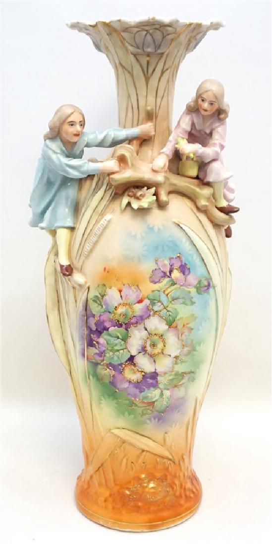 VICTORIAN AUSTRIAN LARGE FIGURAL VASE: Late Victorian Large 22" tall Porcelain Figural Floor Vase marked Austria c. 1910. Two young girls in a tree, paneled front with hand painted purple pansies and beaded gilt enameling. Very good condit