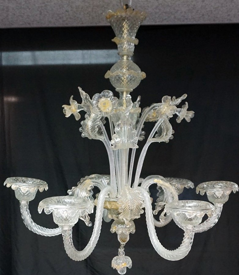 MURANO ITALIAN ART GLASS CHANDELIER: A clear and gold Murano art glass chandelier. Italian. 20th century. Having leaves, floral stems, and gilt accents. Six curved arms, 12 Leaf and Flower inserts and a floral center bobeche. Measures 32