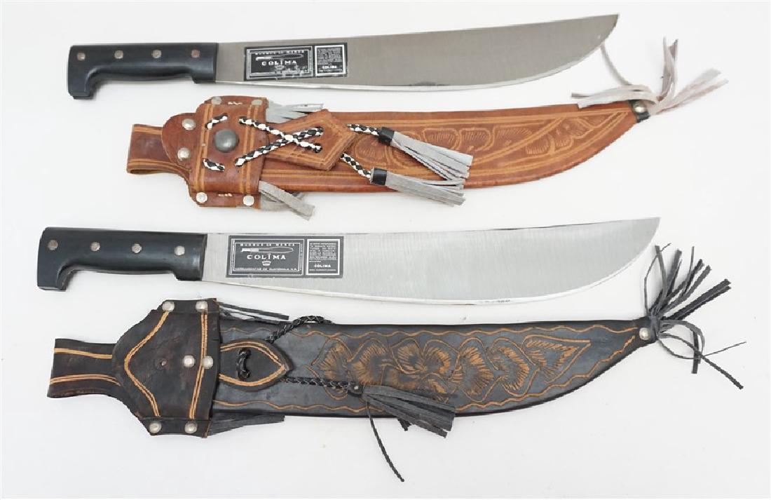2 COLIMA MACHETES IN TOOLED LEATHER SHEATHS: A pair of vintage machetes made by Colima in Guatemala. Each has a long and narrow steel blade, both with the original labels on the blade marked "Busque la Marca/Colima/Herramientas de Guatemala, . T