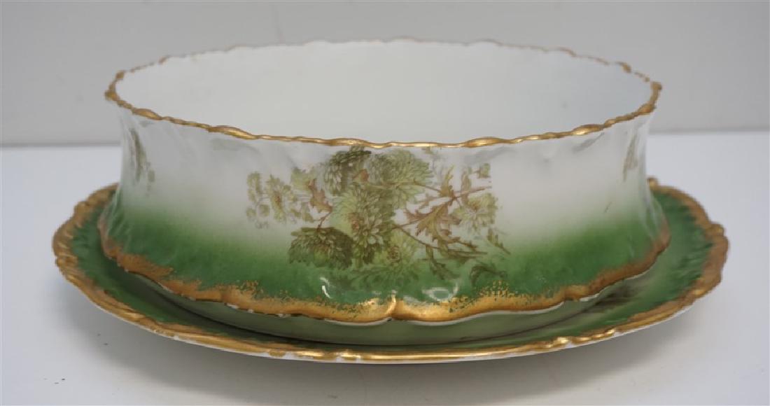 LARGE LIMOGES PUDDING BOWL W UNDERPLATE: Antique factory painted Giant 10 inch Limoges Pudding bowl and 12” diameter matching under-plate. This sculpted gilt rim porcelain set is by the fabled Tressemann & Vogt, and is finished in a gorgeo
