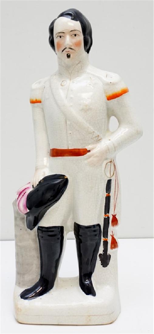 STAFFORDSHIRE NAPOLEON 16": English, ca 1850. A Staffordshire figural, EM Napoleon, depicting the French Emperor Napoleon III in military dress with sword and hat: ht. 16 in. With crazing, including a old line to head. Weight 4 