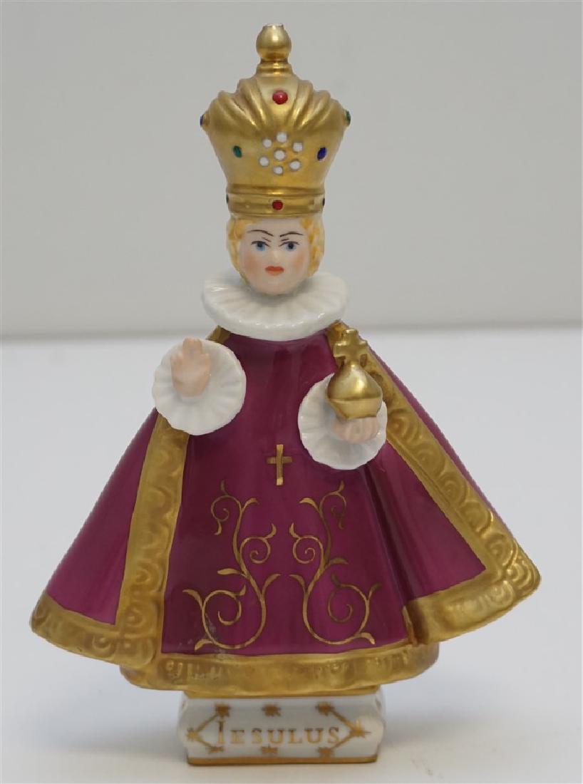 ROYAL DUX INFANT OF PRAGUE: Royal Dux Bohemia Porcelain Infant of Prague. Detailed and , it has the words "gratiosus jesulus pragensis" (Miraculous Infant Jesus of Prague) inscribed around the sides of the base. Measures: 5 3/4"