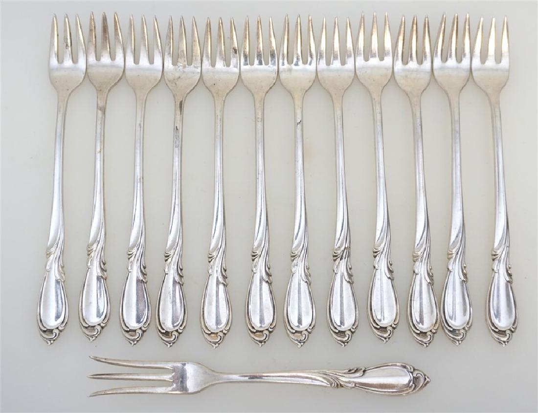 13 STERLING SILVER RHAPSODY COCKTAIL FORKS +: 12 Sterling Silver International Silver Rhapsody Cocktail / Seafood Forks 5-5/8" and 1 Lemon Fork 5-3/8". Excellent condition. No monograms. Weight 280 grams. First produced in 1957, International Rha