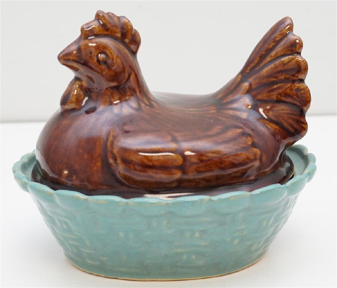 ZANESVILLE HEN ON NEST: Circa 1950s Zanesville John B. Taylor "Country Fare" Stoneware Hen on Nest. Brown hen on blue nest. No marks. small nick to nest edge. Measures 6 3/8"x5 1/4"x5 3/4". Weight 1 pd 10 oz. PROVENANCE: A P