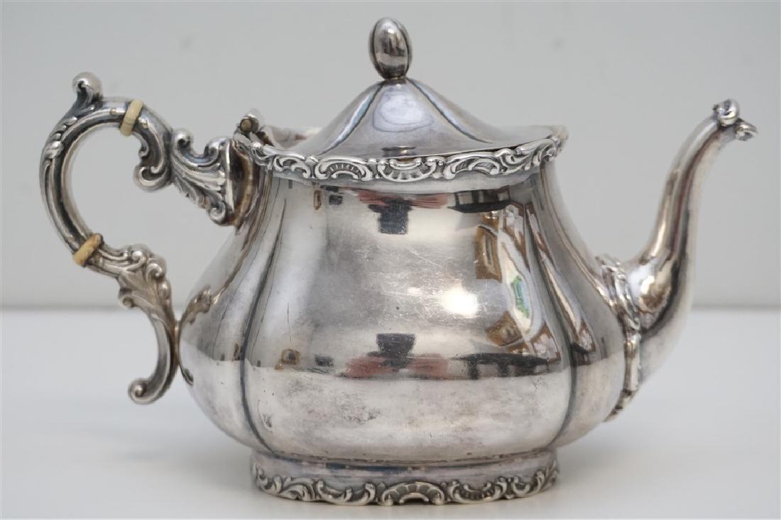 ANTIQUE ENGLISH STERLING TEAPOT: Antique English Small Sterling Silver Teapot retailed by Spaulding & Co., Chicago. Scroll foot, accents and bone spacers. Measures 7"x3-1/4"x5". Weight 355 grams. Founded in 1888 by Henry A. Spaulding