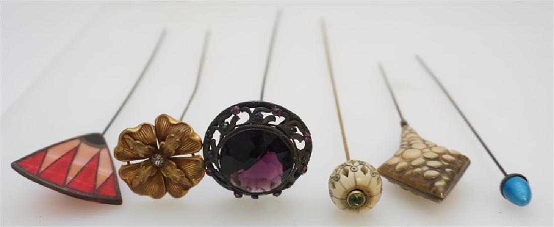 6 ANTIQUE HAT PINS - CZECH GLASS - GILDED: 6 Antique and Vintage Hat Pins. 1- Carved and Pierced Bone Ball with Green Cabochon Accent 9 3/4". 2- Gilded Pansy with Rhinestone Center 8 1/4". 3- Art Deco Bakelite or Celluloid in Pinks and Black 8