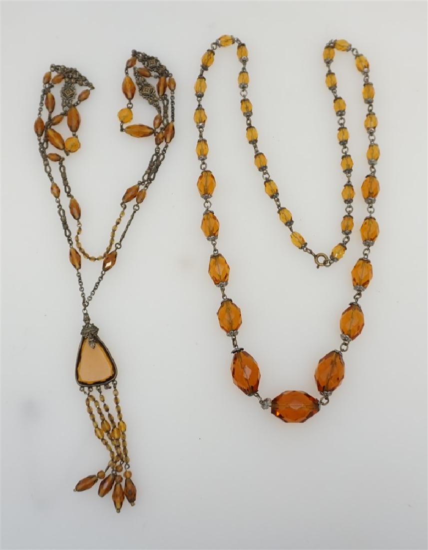 2 VICTORIAN CZECH BOHEMIAN NECKLACES: 2 Victorian Amber Czech Glass Necklaces. One with graduated 28" when opened and the other with teardrop center pendant 34" when opened- missing 1 fringe. Weight 4 oz. PROVENANCE: The Private Estate of