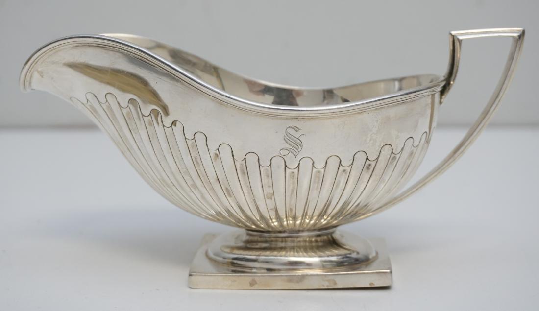 EDWARDIAN STERLING GRAVY BOAT: American Sterling Silver Gravy Boat c. 1910 by Lebkuecher & Co. Fluted on pedestal foot, monogrammed S. Measures 7 1/4"x3 1/2"x3 1/2". Weight 195 grams. PROVENANCE: A Charleston SC Private Estate
