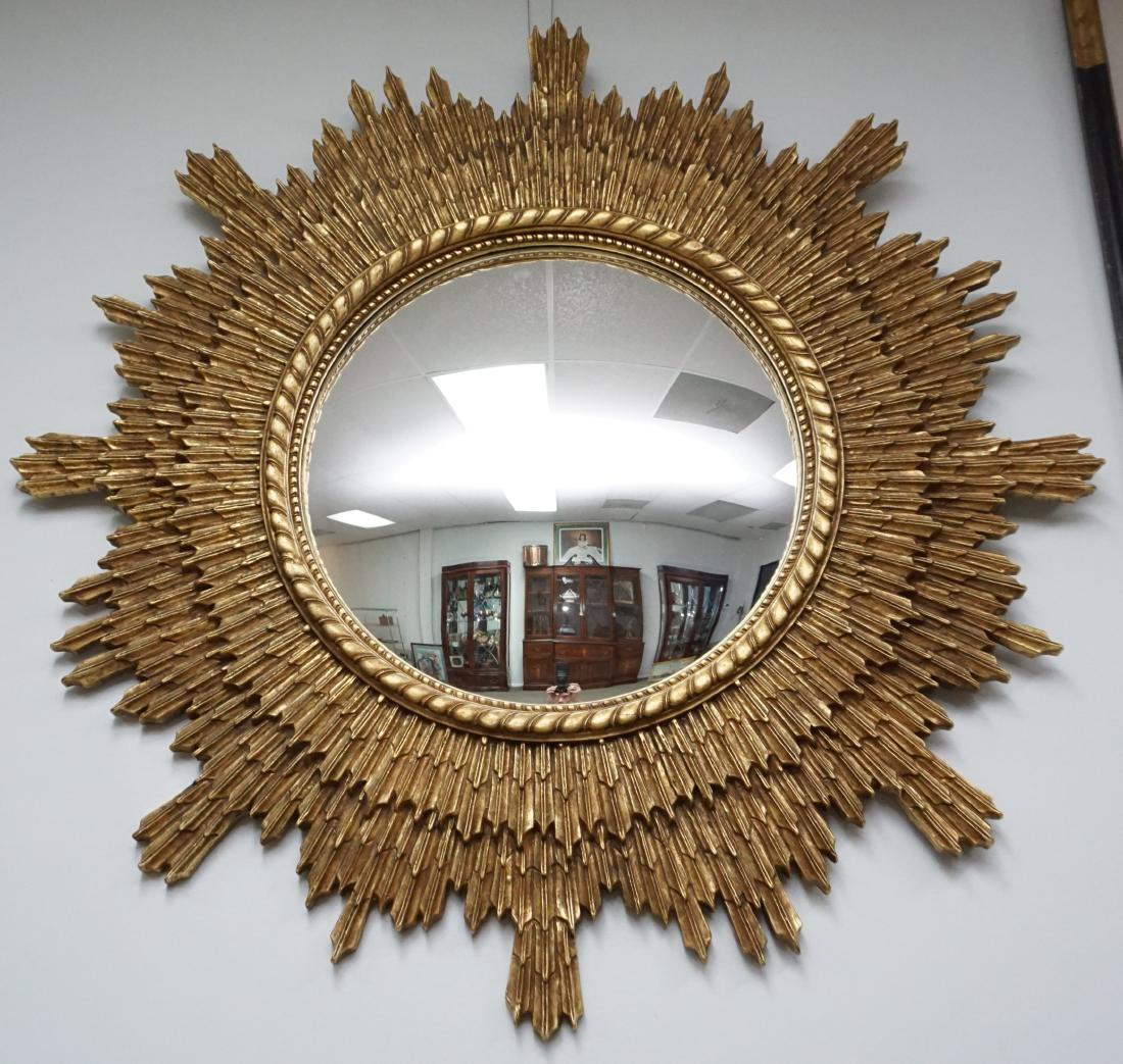 LARGE GILT WOOD STARBURST CONVEX WALL MIRROR: Large Carved Gilt Wood Mid Century Look Starburst Convex Wall Mirror. Measures approximately 4' ftx4'ft x3"deep. Very good condition. PROVENANCE: A Charleston SC Private Estate. *Pickup only or Shippi
