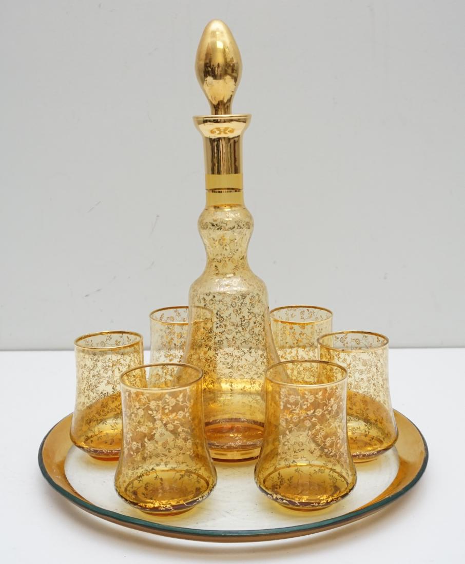ITALIAN MID CENTURY 8 pc LIQUOR SET: Mid-Century Elegance. Murano Venetian Art Glass Decanter with 6 Glasses and Glass Tray. Tray 12"x12". Decanter 13". Glasses 3 3/4". Weight on all 4 pds. PROVENANCE: A Private Charleston SC Estate.