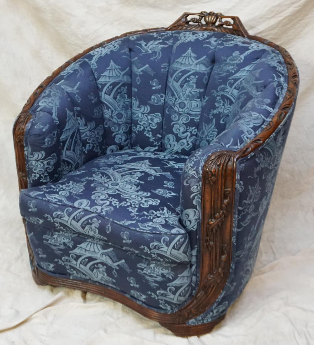 ART DECO CLUB CHAIR - CHINOISERIE: Art Deco Club Chair. Carved arms, crest and base, blue silk brocade Chinoiserie upholstery. On original swivel castors which work well. Very good condition. Measures 35 x 35 x 33". PROVENANCE: A Priva