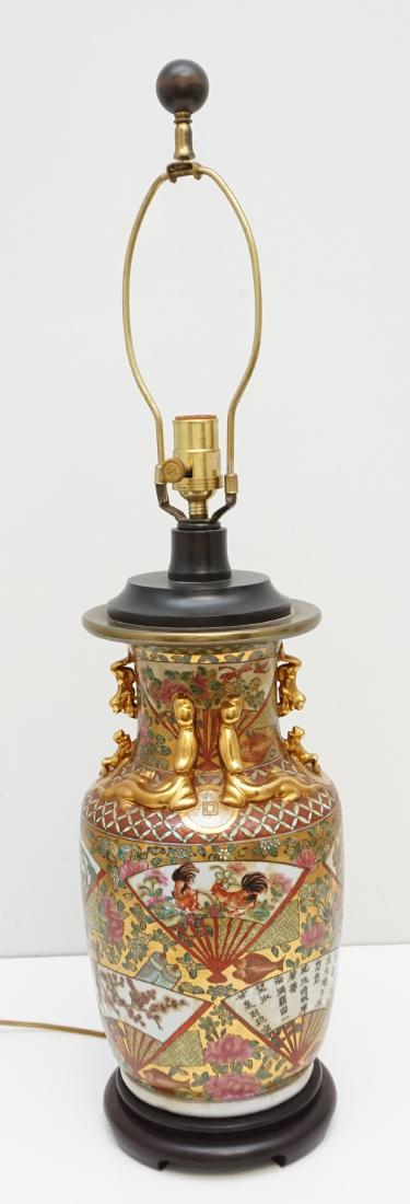 LARGE CHINESE GILDED PORCELAIN LAMP: Vintage Mid Century Large Chinese Porcelain Enameled Lamp. Fans, Koi Fish, Birds, Gilt Foo Dog and Dragon accents. On wood Base. Lamp measures 8"x8"x21" without harp. Weight 8 pds 5 oz. PROVENANCE: A 