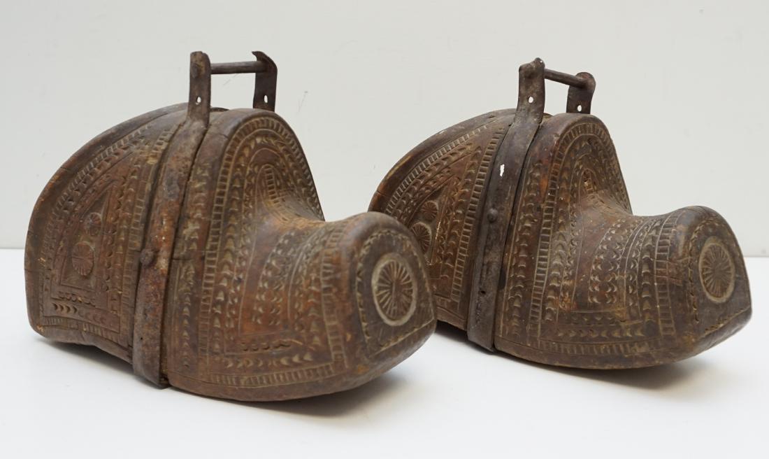 ANTIQUE SPANISH COLONIAL WOOD STIRRUPS: Antique pair of Chilean wooden stirrups. Also known as estribos, these stirrups are carved from a solid block of wood. Taking the shape of the toes of boots, the stirrups are hand carved with an intri