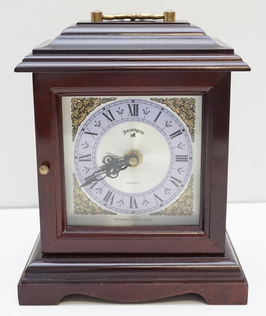 KENSINGTON QUARTZ CLOCK: Kensington Mahogany Cased Quartz Movement Mantle Clock. Battery operated, no battery, untested. Measures 7 1/2"x5"x9". Weight 2 pds 10 oz. PROVENANCE: A Charleston SC Private Estate