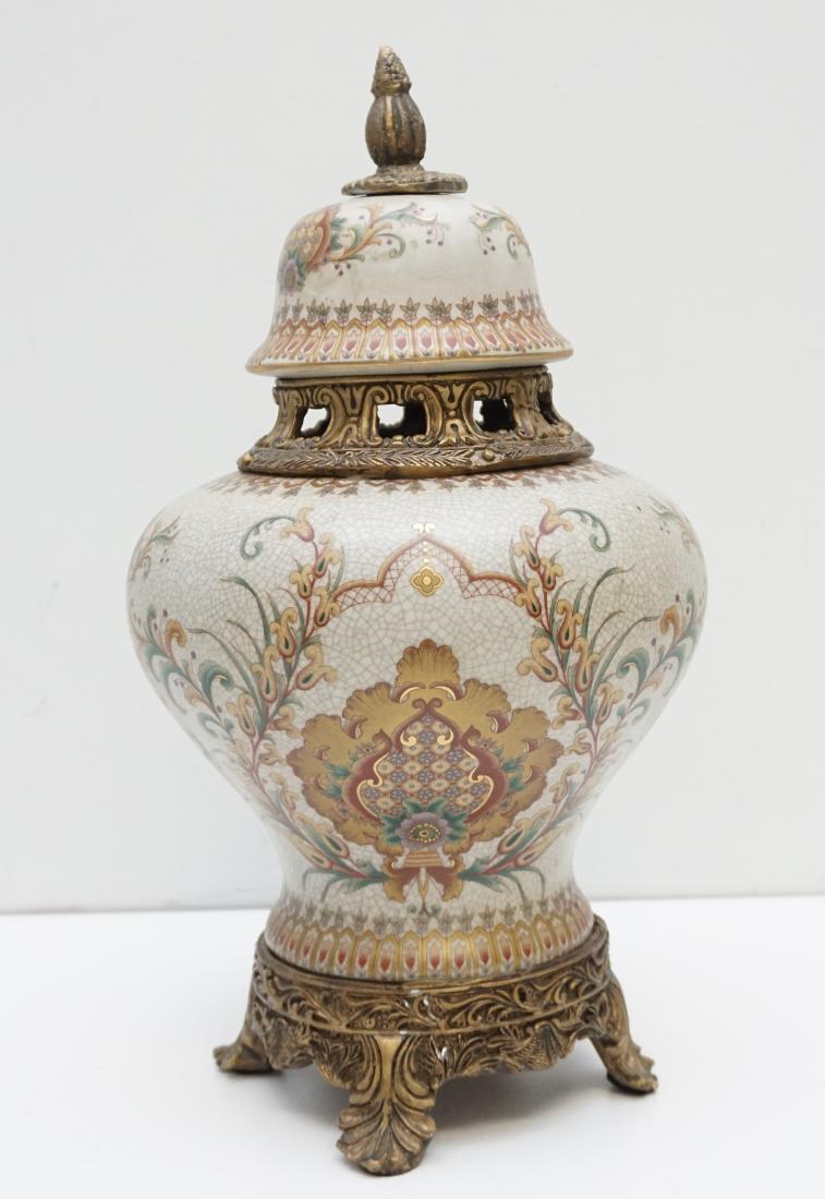 ORMOLU MOUNTED PORCELAIN VASE: Vintage Ormolu Mounted Porcelain Vase in the French Style. The entire vase is porcelain with the foot and neck composite painted in a bronzed gilt to resemble metal. The vase is floral and geometric w