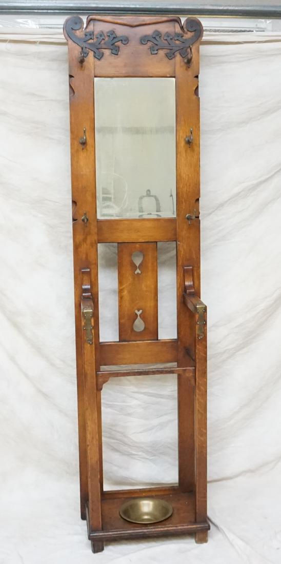 ANTIQUE ARTS & CRAFTS OAK HALL STAND: Antique Arts & Crafts Era Solid Oak Hall Stand. With original beveled glass mirror, six hooks for hats and brass insert for umbrellas. Brass patinated accents. Good condition. Wire on back to secure t