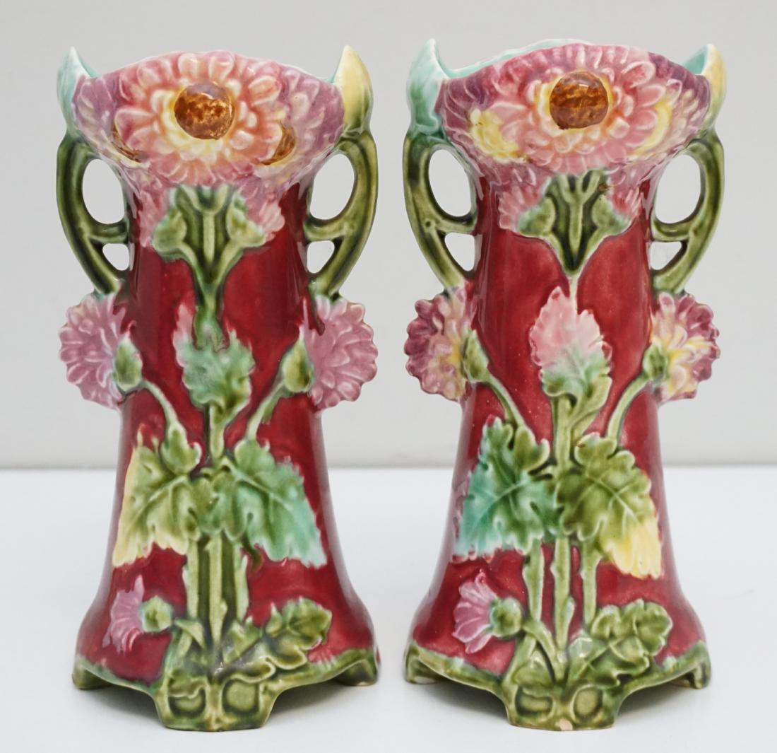 2 ANTIQUE ART NOUVEAU MAJOLICA VASES: Matched Pair of Antique Majolica Art Nouveau Fuchsia and Pink Floral Vases. Turquoise inside. One vase internal hairline, chip to foot, the other with tiny nick to foot. The pair displays well. Each 3